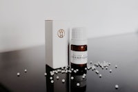 a bottle of essential oil sitting on a table next to a box