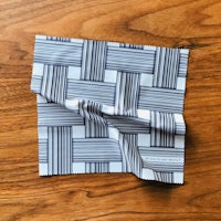 a blue and white striped cloth on top of a wooden table