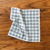 a black and white checkered cloth on a wooden table