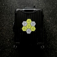 a black suitcase with a geometric design on it